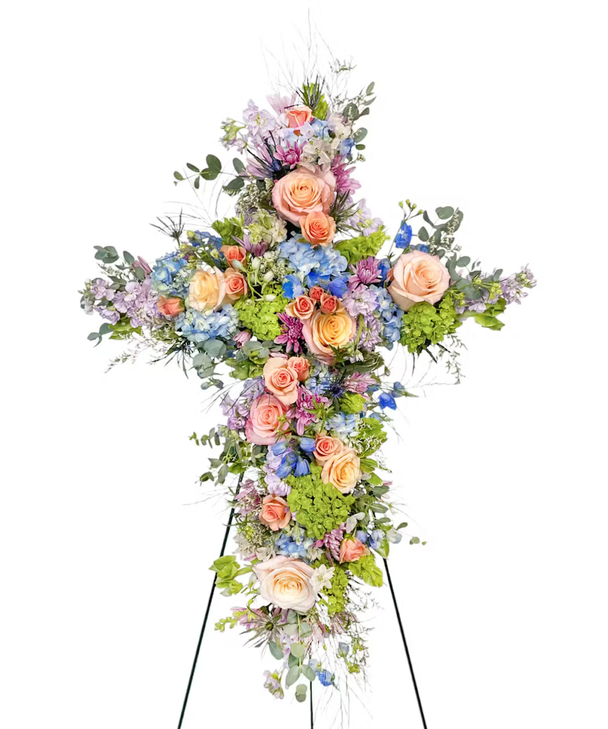 Floral cross arrangement on a stand with pastel flowers on a white background.